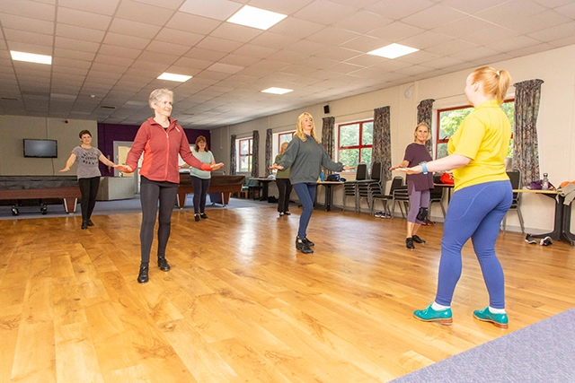 Tap A group of women are participating in a tap dance class