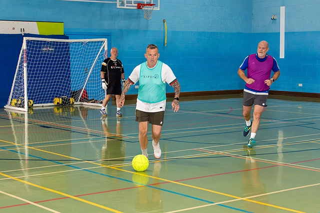 A male pickleball player in sports hall